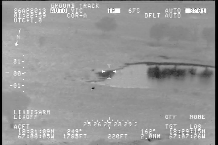 The object low over the Aguadilla coastline, with the telemetry showing an altitude reading and a slant range of 2.0 nautical miles. The footage twice crosses the airspace of Rafael Hernandez Airport before the object heads back out to sea.