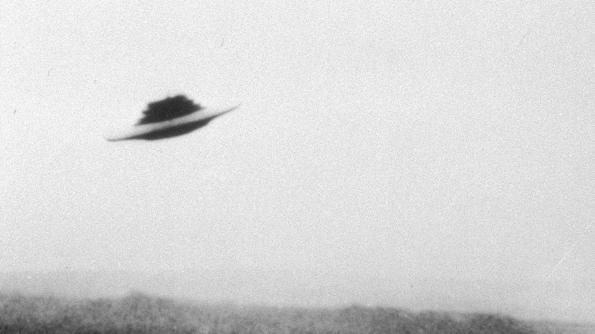 A press copy print of one of Meier's beamship photographs, the flat-rimmed saucer with its dark upper structure over a hazy Swiss ridgeline, as it circulated through photo agencies. The New Yorker ran this print in August 2023, credited to Getty.