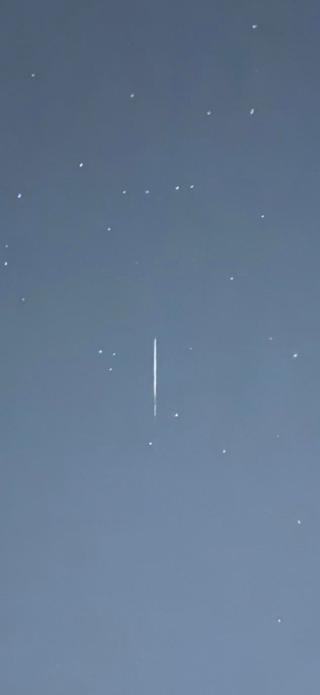 The magnified version the witness shared, isolating the streak against the stars. Witness photograph.
