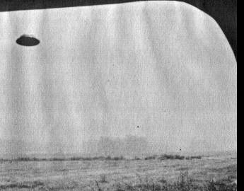 Another of the four Heflin frames, the domed, hat-shaped disc tilted against the open sky near Myford Road, with the dark midsection band visible.
