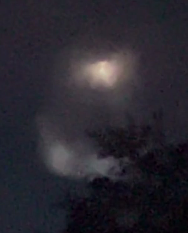 A zoomed crop of the light. The bright core with a softer halo, and a fainter second glow below, are consistent with one bright source and an internal lens reflection.